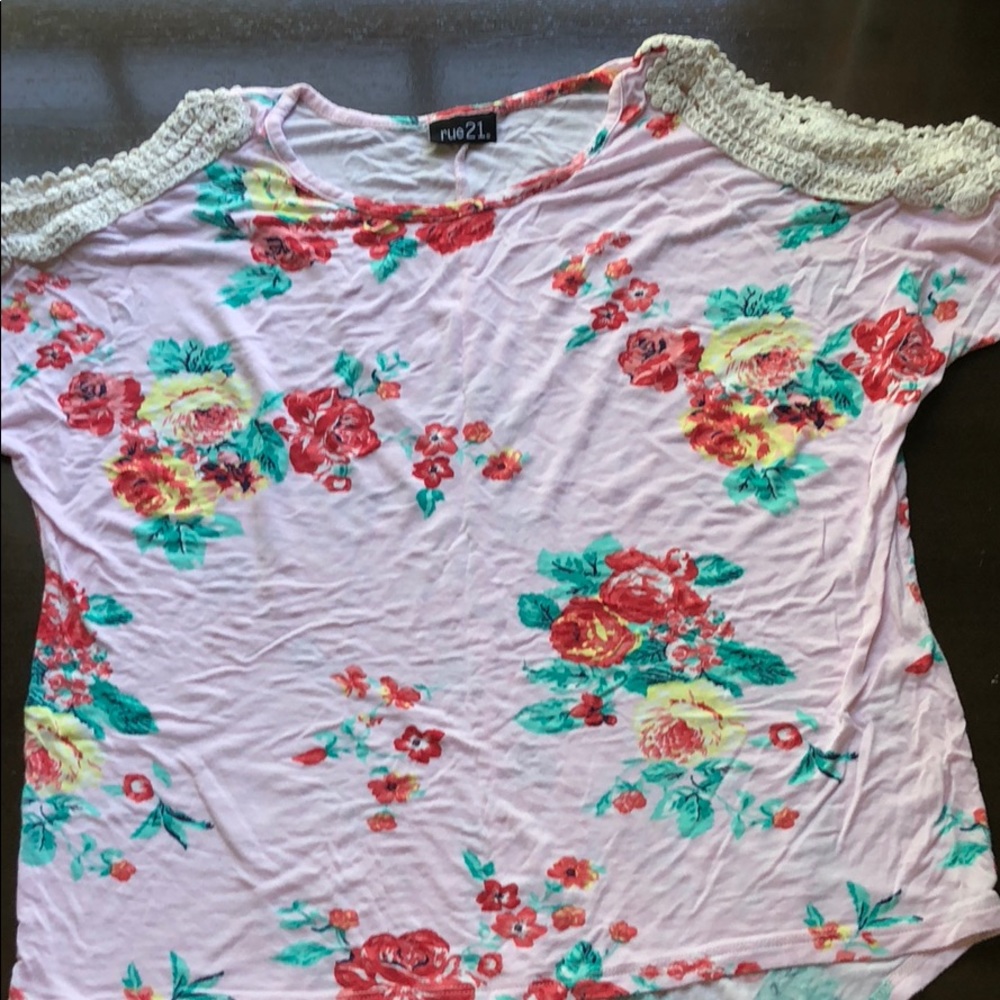 A pink cold shoulder top with floral prints